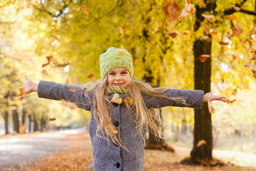 little girl walks in the autumn