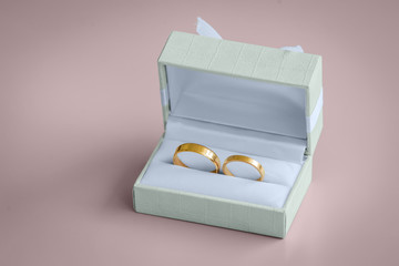 Beautiful golden wedding rings inside a vintage box