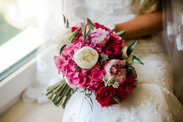 Bride holding delicate marriage bouquet