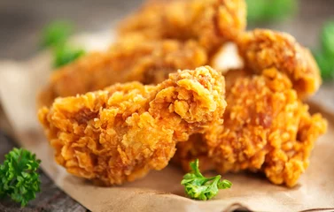  Crispy fried kentucky chicken wings on wooden table © Subbotina Anna