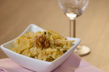Serving of risotto (paella,pilaf) with walnuts and white wine