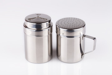 Stainless steel salt and pepper shakers isolated on white