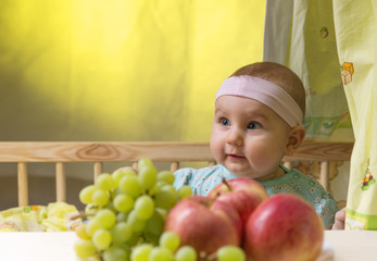 Fototapeta na wymiar dear small emotional child near a fresh fruits