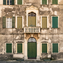 Fototapeta na wymiar Facade of an ancient abandoned Italian villa.