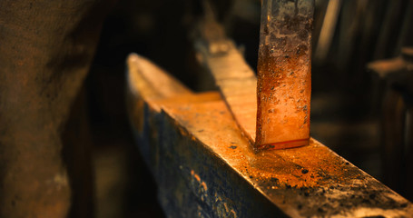 Rod hot iron on the anvil.