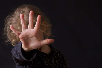 child hid face with hands