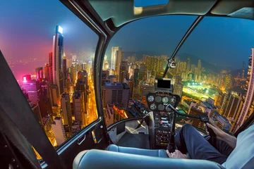 Papier Peint photo Lavable Hong Kong Helicopter cockpit flying on Hong Kong skyscrapers at night in Wan Chai district, Hong Kong island. Fisheye view.
