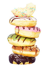 Isolated tower of assorted donuts (chocolate, pistachio, caramel, vanilla, strawberry flavor) on white background. Close-up. 