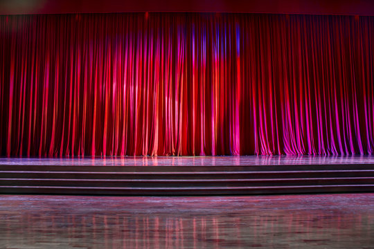 Red curtains and wooden stage.