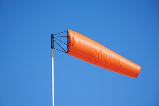 close up on orange windsock in the wind