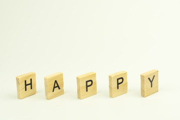 Text wooden blocks spelling the word HAPPY on white background