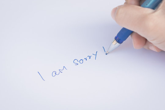 Say Sorry With A Text Message On Paper And Pen