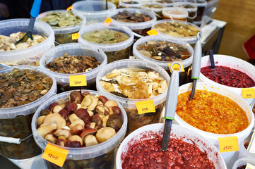 Salted mushrooms and jams on market