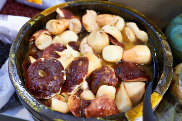 Salted white mushrooms on barrel