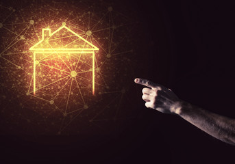 Conceptual image with hand pointing at house or main page icon o