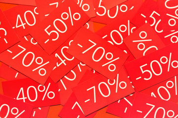 Discounts 40, 50 and 70 percents. Background with red tags with percentages