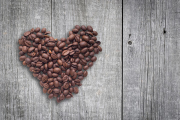 Coffee beans in form of heart on beautifull background. Love. Insparation. On wooden background.