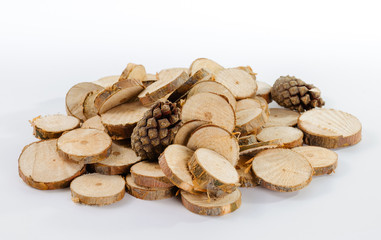 Pile of little round pieces of sawn pine branches and pine cones