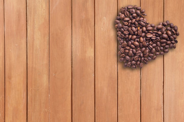 Coffee beans in form of heart on beautifull background. Love. Insparation. On wooden background.
