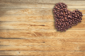 Coffee beans in form of heart on beautifull background. Love. Insparation. On wooden background.