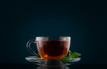 Tea Cup with mint leaves on a dark background
