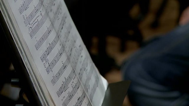 Rehearsal of the symphonic orchestra, page turning with notes