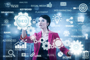 Beautiful entrepreneur using SEO button