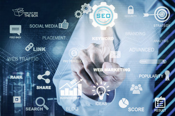 Businessman hand touches SEO icon