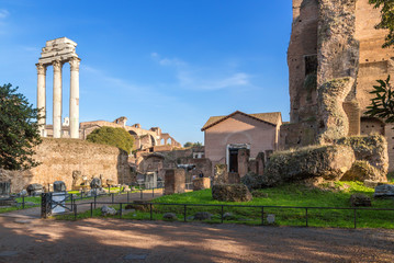 Fototapeta na wymiar Rome, Italy. Ruins of the Roman Forum: the temple of Castor and Pollux (484 BC), the Church of Santa Maria Antiqua (1st century AD)
