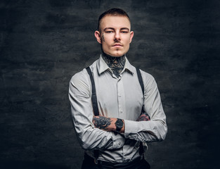 A man with a tattoo on his face and arms.