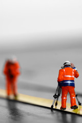 Obraz premium Scale model construction workers on a tape measure with selective colour