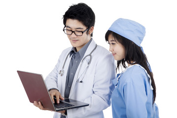 Doctor and surgeon discussing with laptop