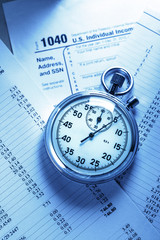 Tax form, operating budget and stopwatch