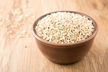 green buckwheat on wooden table. Healthy diet concept food