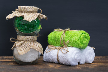 two cans with sea salt and towels in the bathroom