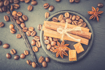 Roasted coffee beans background. Coffee beans with copy space for text. Seasoning. Spice. Cinnamon. Badian. Vanilla