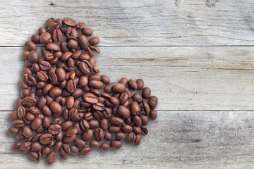 Coffee beans in form of heart on beautifull background. Love. Insparation. On wooden background.