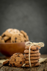 Still life of Close up stacked chocolate chip cookies on  napkin with rustic background