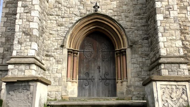 A wooden door in an old stone building.