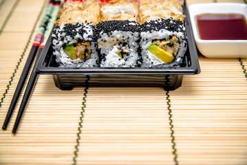 a plate of sushi pieces standing on a bamboo napkin 