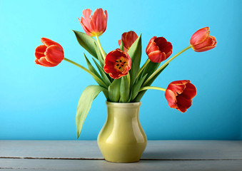 bouquet flowers tulips vase white wooden table blue background