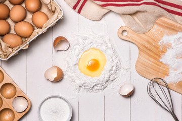 Egg in flour. Making dough background. Baking with raw eggs, sugar, flour , milk