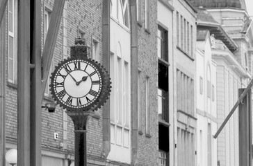 Fototapeta na wymiar Street clock against colorful buildings in Cork, Ireland