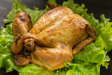 baked chicken on lettuce leaves