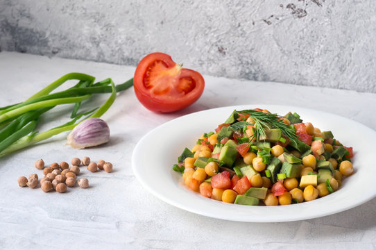 Healthy salad with avocado, chickpea and tomato. Simple stylish food photo