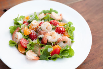 Grilled shrimp salad on wood table