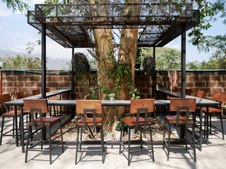 Dining counter bar with chairs under the tree