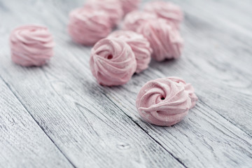 Pink zephyr on grey wooden background
