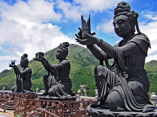 Buddhist statues in Ngong Ping on the island of Lantau in Hong Kong, praising and making offerings to the Tian Tan Buddha