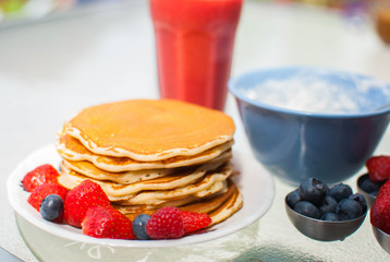 breakfast with pancakes berries and a smoothie